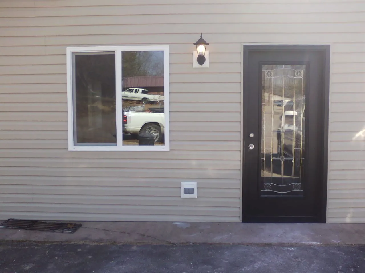 New siding, window and entry door on the side of an addition in Chaptico